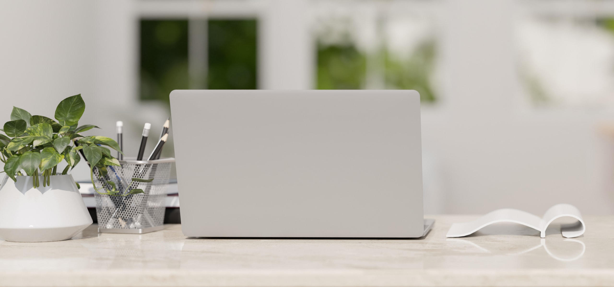 White laptop and notepad on a desk